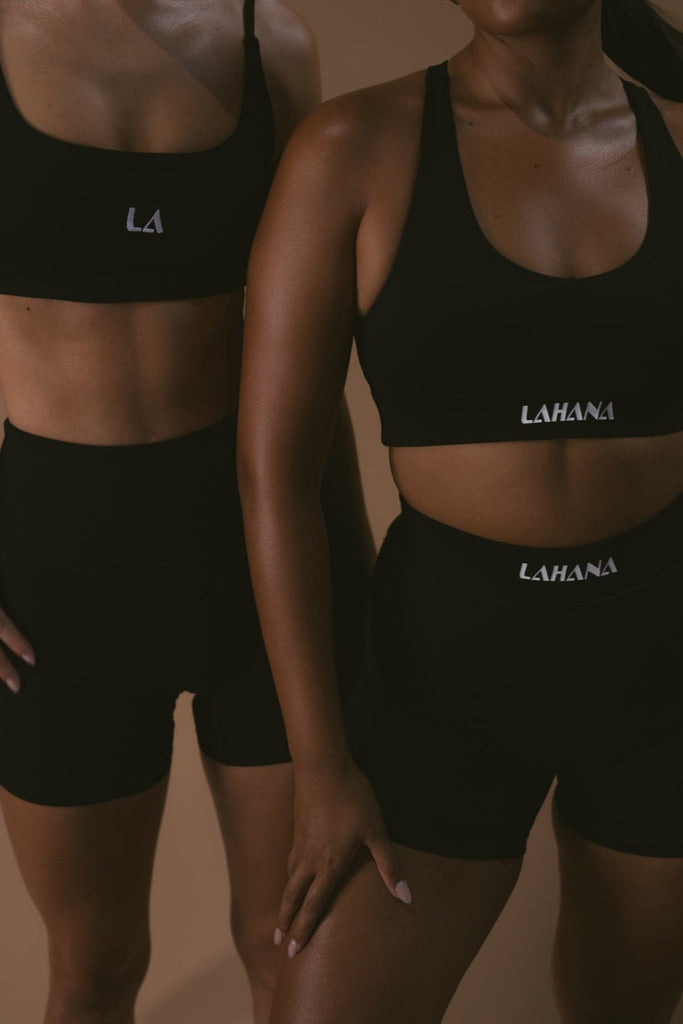 Two models wearing the Lahana Active Sanaa Crop Top in Black with matching bike shorts.