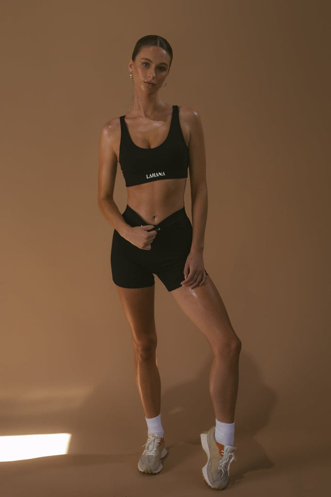 A model wearing the Lahana Active Sanaa Crop Top in Black with matching bike shorts.